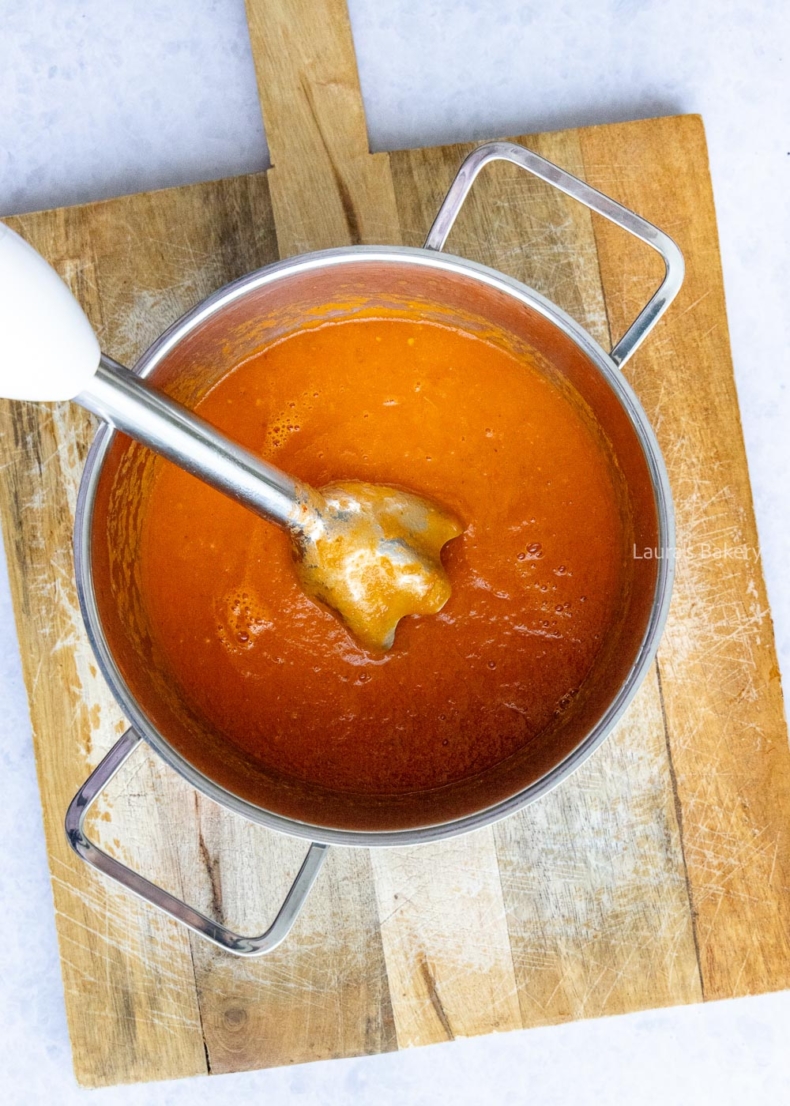 Blending the Italian tomato soup with an immersion blender