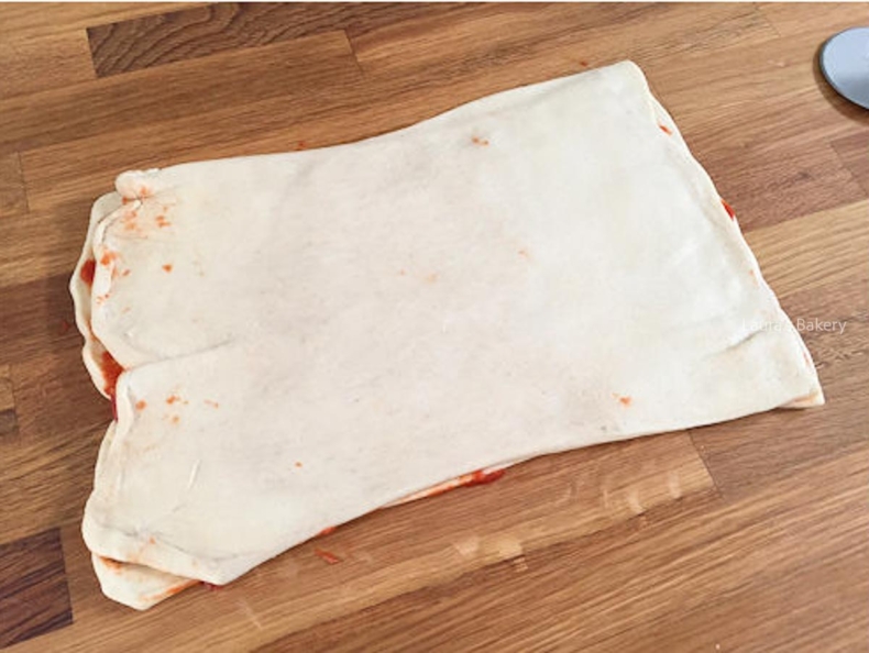 Pizza dough cut in half