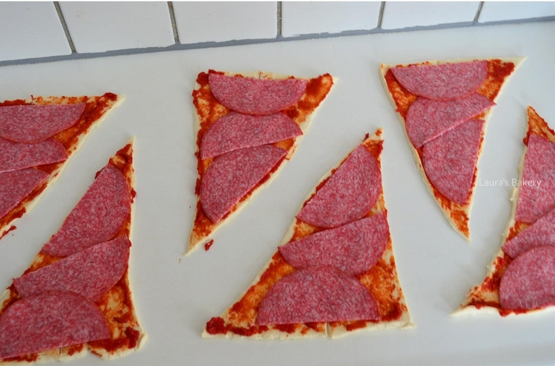 Slices of salami added to the pizza crescent dough