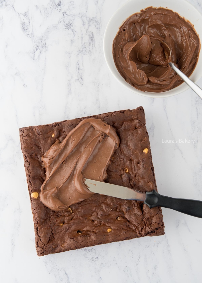 Ferrero rocher brownie base with chocolate Nutella topping being spread over