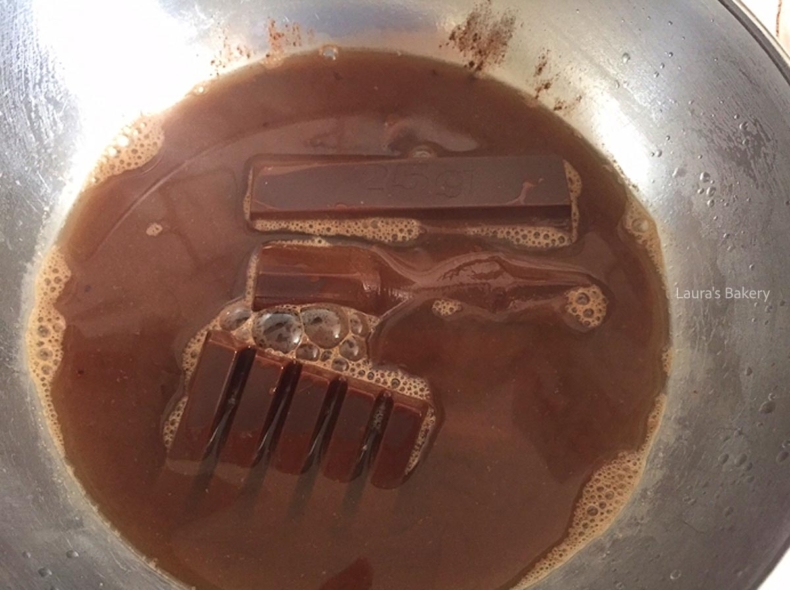 Melted dark chocolate mixture in a mixing bowl for Oreo bundt cake.