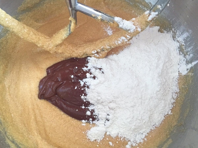 Flour, baking soda, salt, and chocolate mixture added to the batter for Oreo bundt cake.